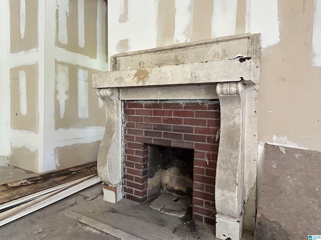 interior details featuring a brick fireplace