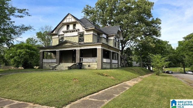 victorian house with a front lawn and covered porch