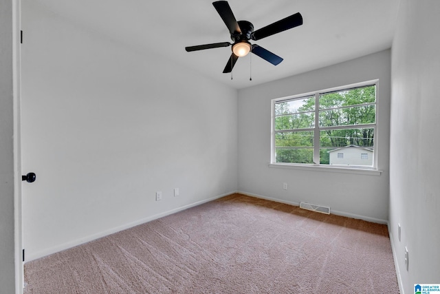 unfurnished room featuring light carpet and ceiling fan