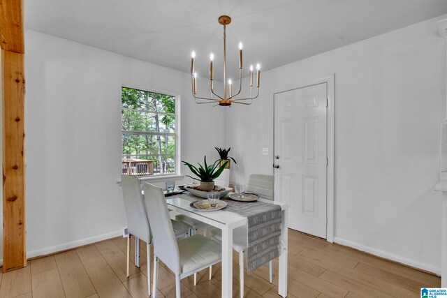 dining area featuring an inviting chandelier and light hardwood / wood-style floors