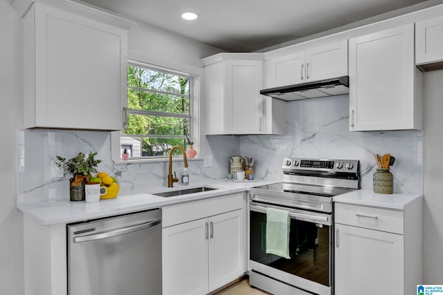 kitchen featuring stainless steel appliances, white cabinets, and sink