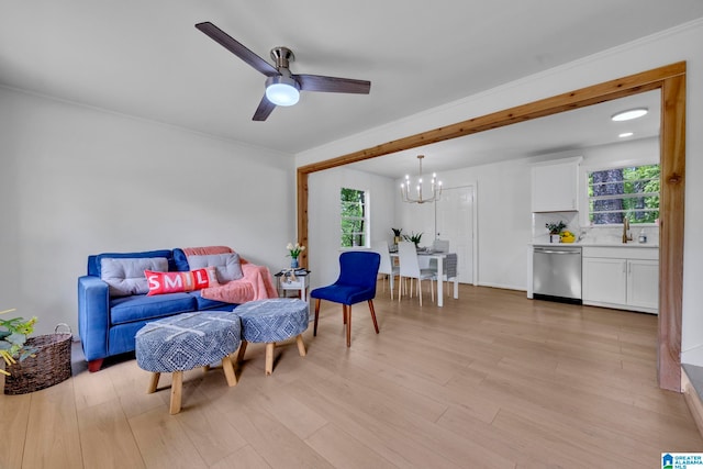 sitting room featuring a healthy amount of sunlight, light wood-type flooring, and ceiling fan with notable chandelier