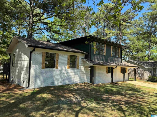 split level home featuring a front lawn