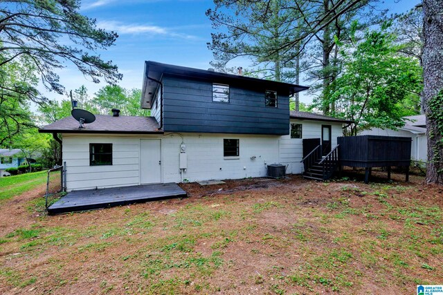 rear view of house featuring cooling unit and a deck