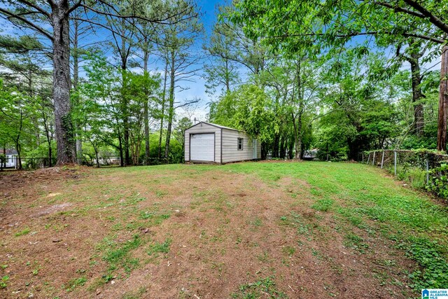 view of yard featuring an outbuilding and a garage