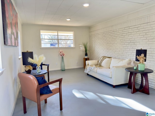 living room with concrete flooring, ornamental molding, and brick wall