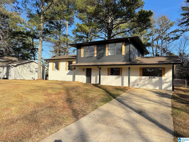 view of front of property with a garage and a front lawn