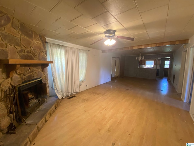 unfurnished living room featuring a fireplace, hardwood / wood-style floors, and ceiling fan