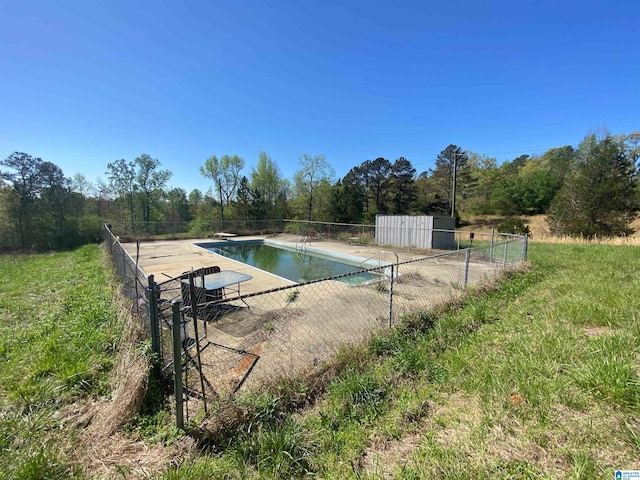 view of swimming pool featuring a diving board and a storage unit