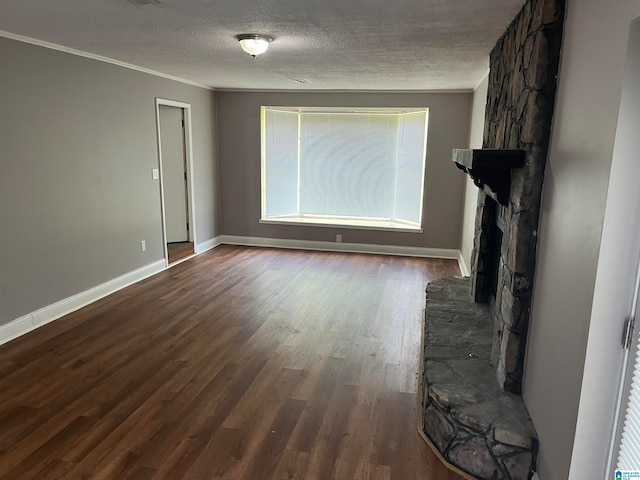 unfurnished living room with ornamental molding, dark hardwood / wood-style floors, a textured ceiling, and a fireplace