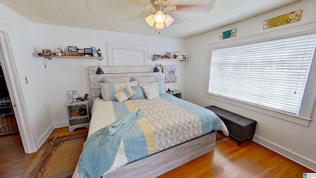 bedroom with wood-type flooring and ceiling fan