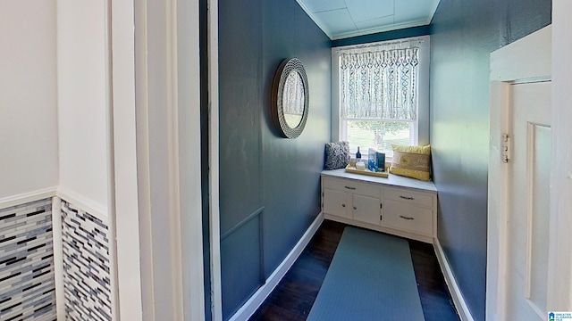 interior space with ornamental molding and dark hardwood / wood-style flooring