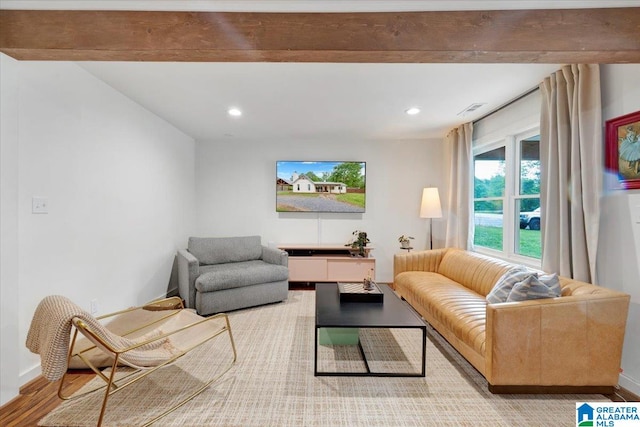 living room featuring beam ceiling and light wood-type flooring