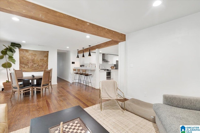 living room with hardwood / wood-style floors and beamed ceiling