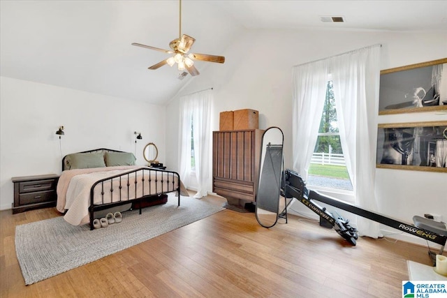 bedroom featuring light hardwood / wood-style flooring, ceiling fan, and lofted ceiling