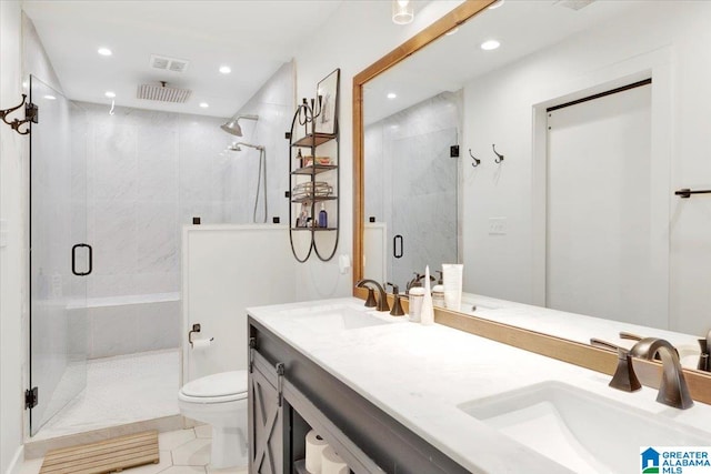 bathroom featuring tile patterned floors, toilet, vanity, and walk in shower