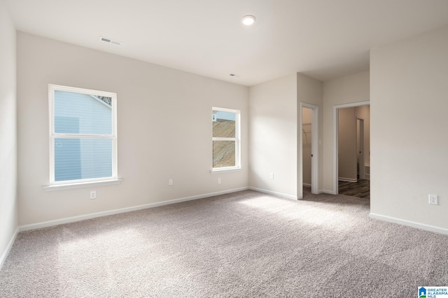 unfurnished room with light colored carpet