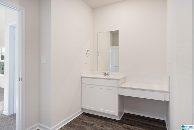 bathroom featuring hardwood / wood-style floors and vanity with extensive cabinet space