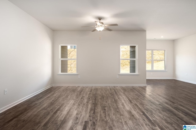 spare room featuring ceiling fan and dark wood-type flooring