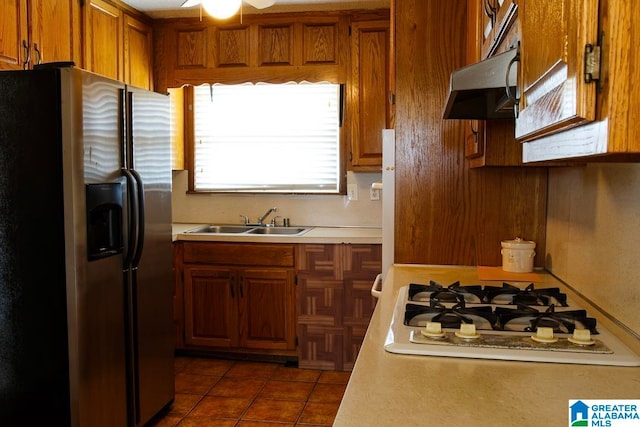 kitchen with ventilation hood, stainless steel fridge with ice dispenser, ceiling fan, sink, and white gas cooktop