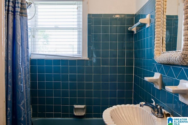 bathroom with shower / tub combo and tile walls