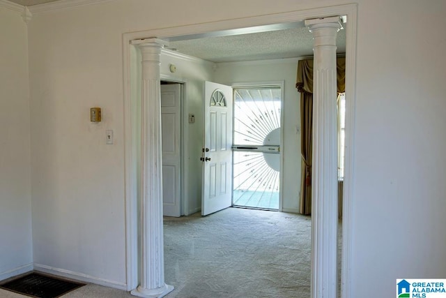 corridor with ornamental molding, light carpet, and ornate columns