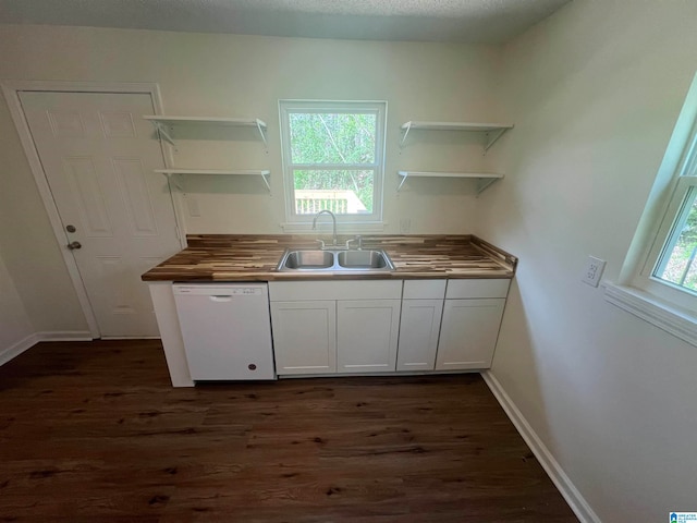 kitchen with wooden counters, sink, dark wood-type flooring, and dishwasher