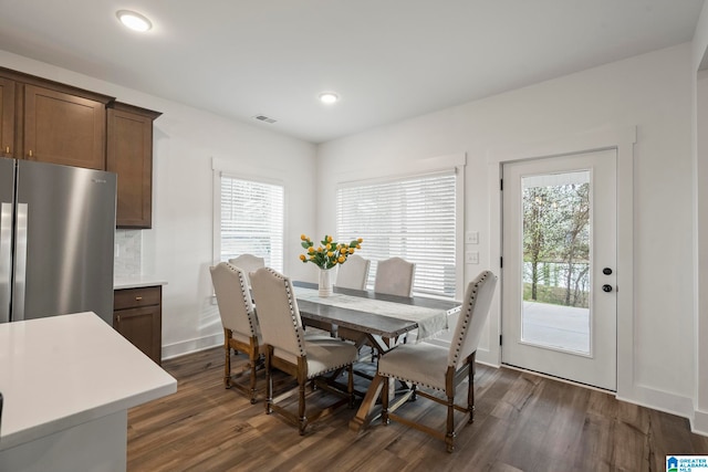 dining area with a healthy amount of sunlight and dark hardwood / wood-style floors