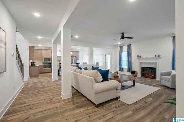 living room featuring ceiling fan and dark hardwood / wood-style flooring