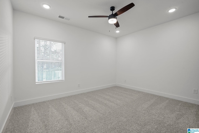 carpeted spare room with ceiling fan and a wealth of natural light