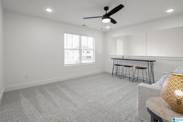 sitting room with light colored carpet and ceiling fan