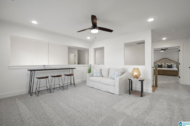 living room featuring light carpet and ceiling fan