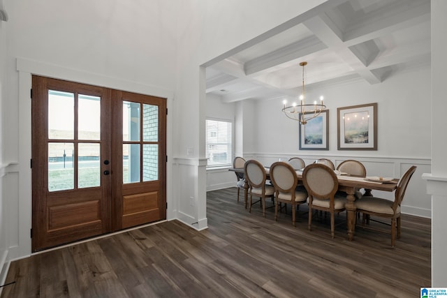 entryway with french doors, dark wood-type flooring, a chandelier, beam ceiling, and coffered ceiling