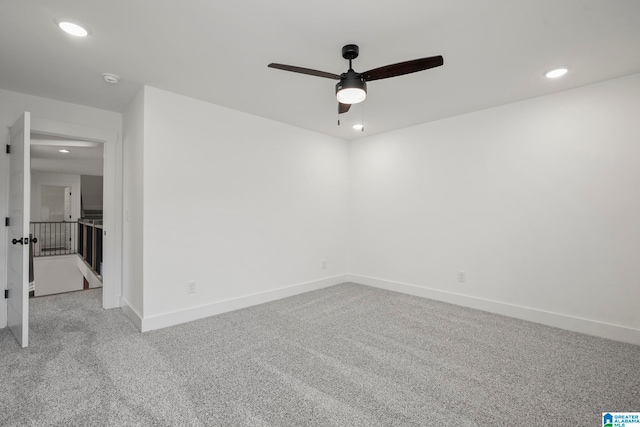 spare room with light colored carpet and ceiling fan