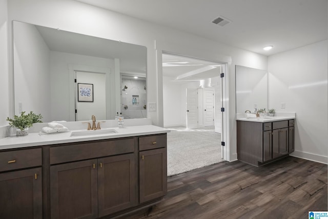 bathroom with hardwood / wood-style flooring and dual bowl vanity