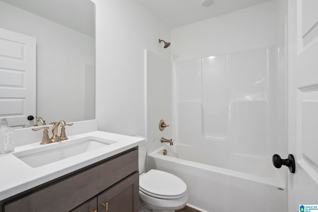 full bathroom featuring toilet, vanity, and washtub / shower combination