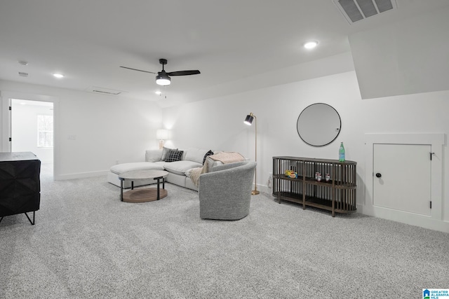 carpeted living room with ceiling fan