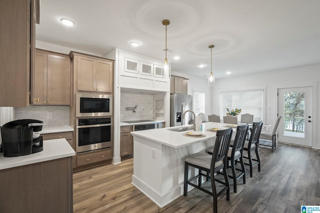 kitchen featuring decorative light fixtures, backsplash, black appliances, and dark wood-type flooring