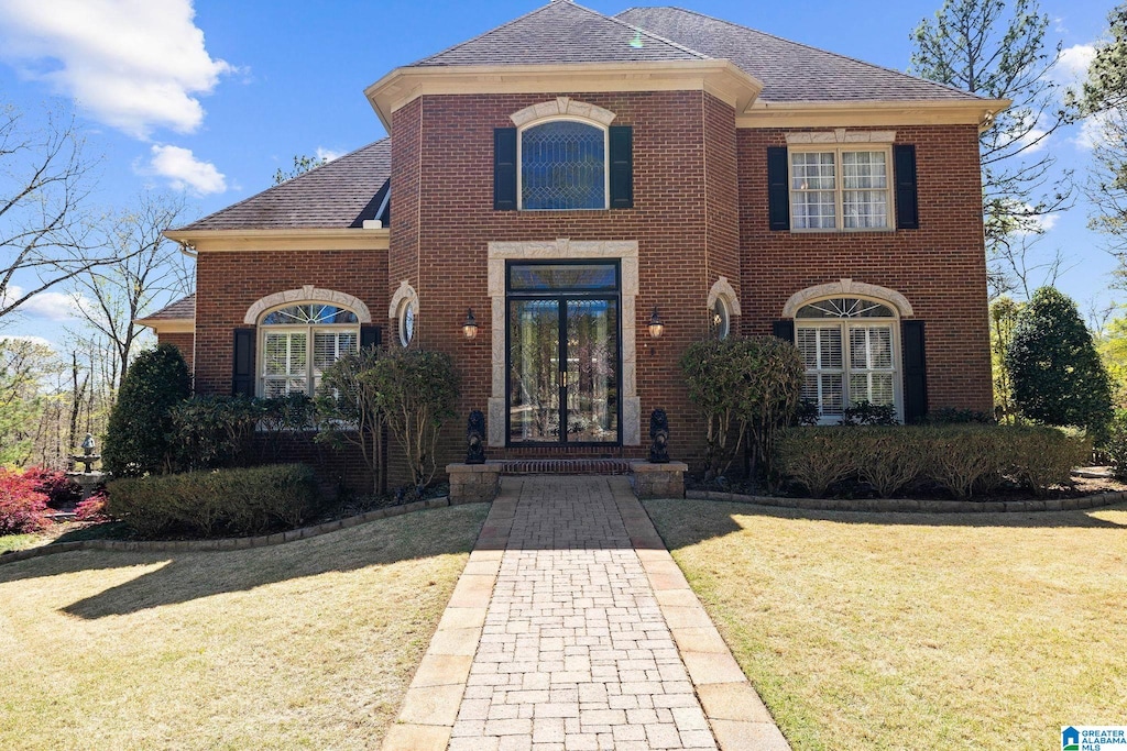 view of front of property with a front yard and french doors