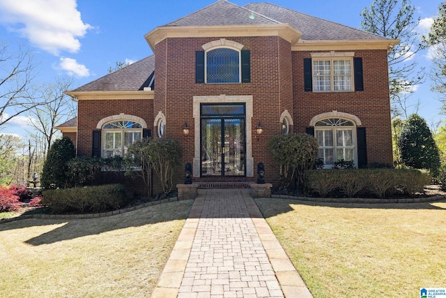 view of front of property with a front yard and french doors