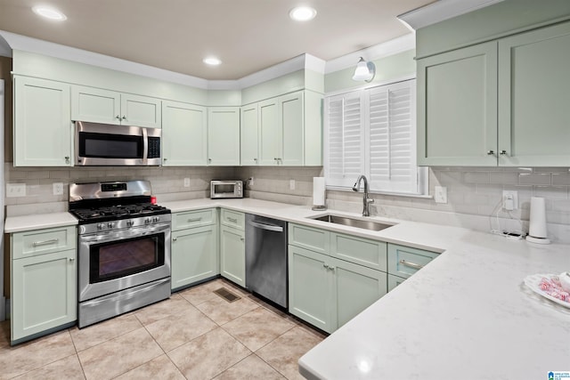 kitchen with sink, tasteful backsplash, and stainless steel appliances