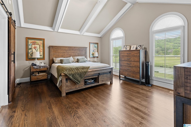 bedroom with a barn door, beam ceiling, dark hardwood / wood-style floors, and multiple windows