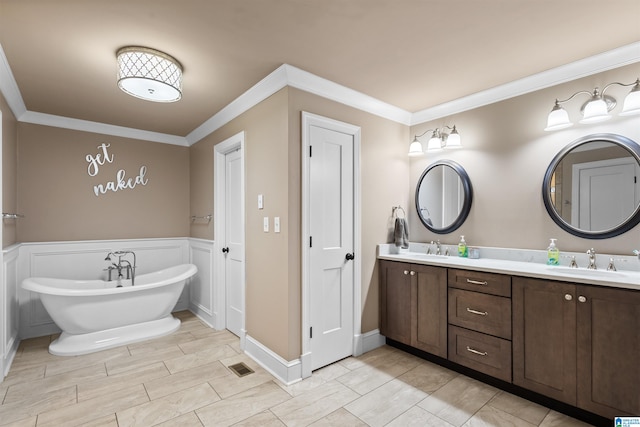 bathroom featuring dual sinks, oversized vanity, crown molding, and tile floors