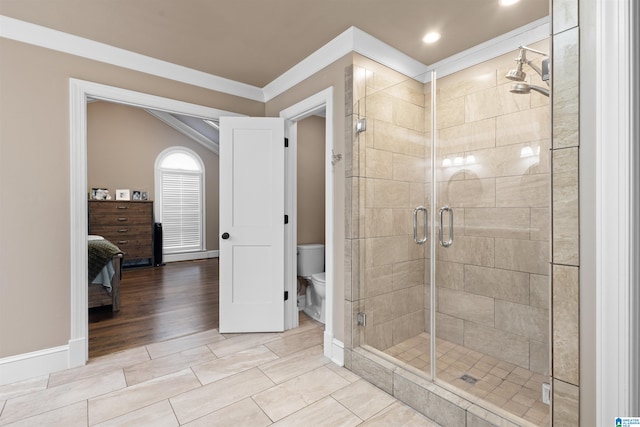 bathroom with hardwood / wood-style floors, crown molding, toilet, and a shower with shower door