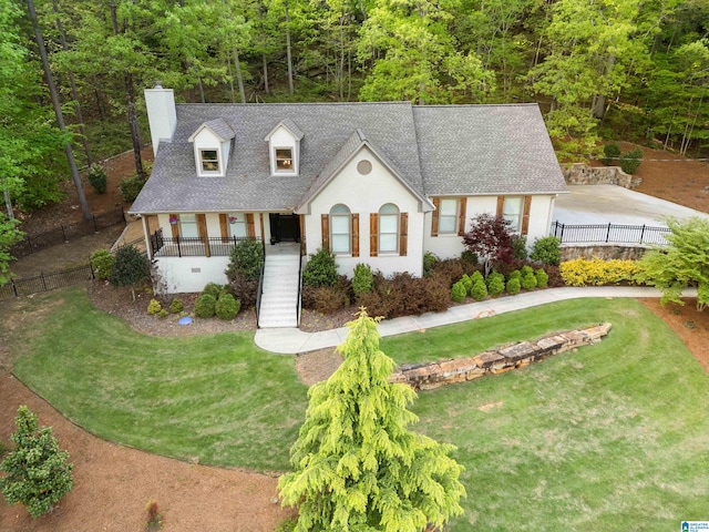 view of front of home with a porch and a front yard