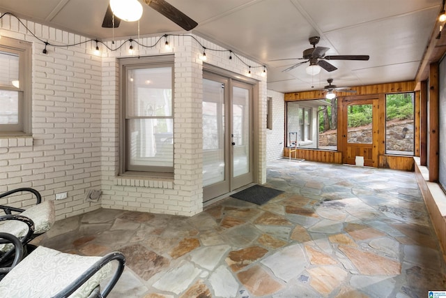 sunroom featuring french doors and ceiling fan