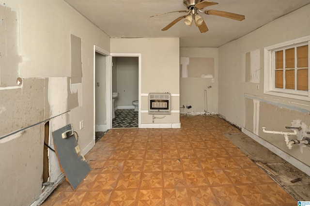 2335 10th Ave, Birmingham, AL 35205 - unfurnished living room featuring ceiling fan, a wood stove, and light parquet flooring