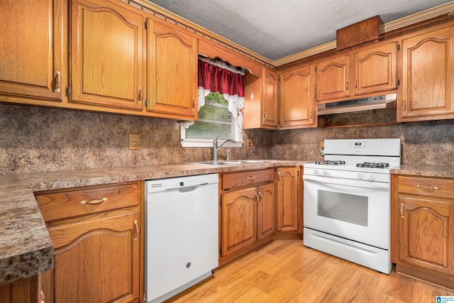 kitchen with a textured ceiling, sink, white appliances, backsplash, and light wood-type flooring