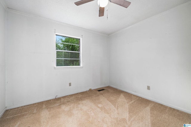 carpeted empty room featuring ceiling fan and crown molding