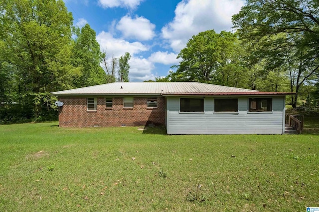 back of property featuring a yard